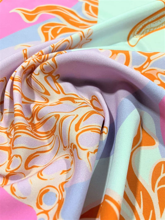 Seda francesa con estampado marino de coral naranja sobre fondo pastel, detalle de tela