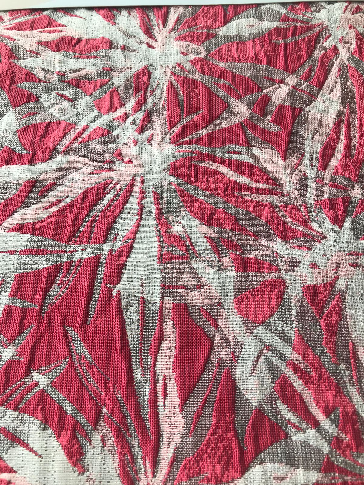 Patrón de follaje repetido en jacquard coral y plata, vista superior